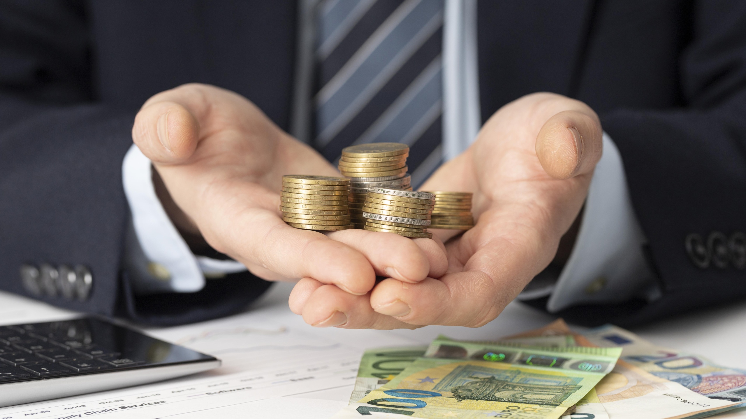 businessman holding bunch coins scaled 1